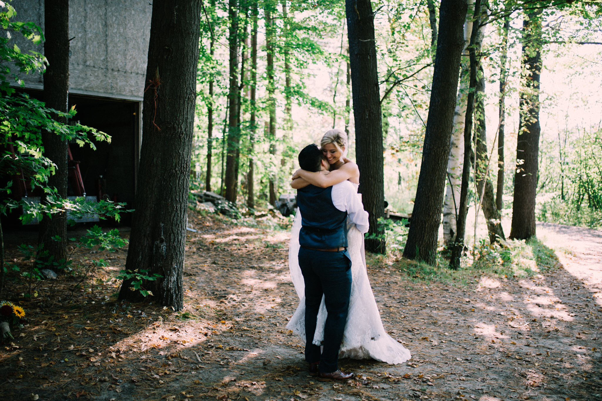 bride and groom hugging in a forest