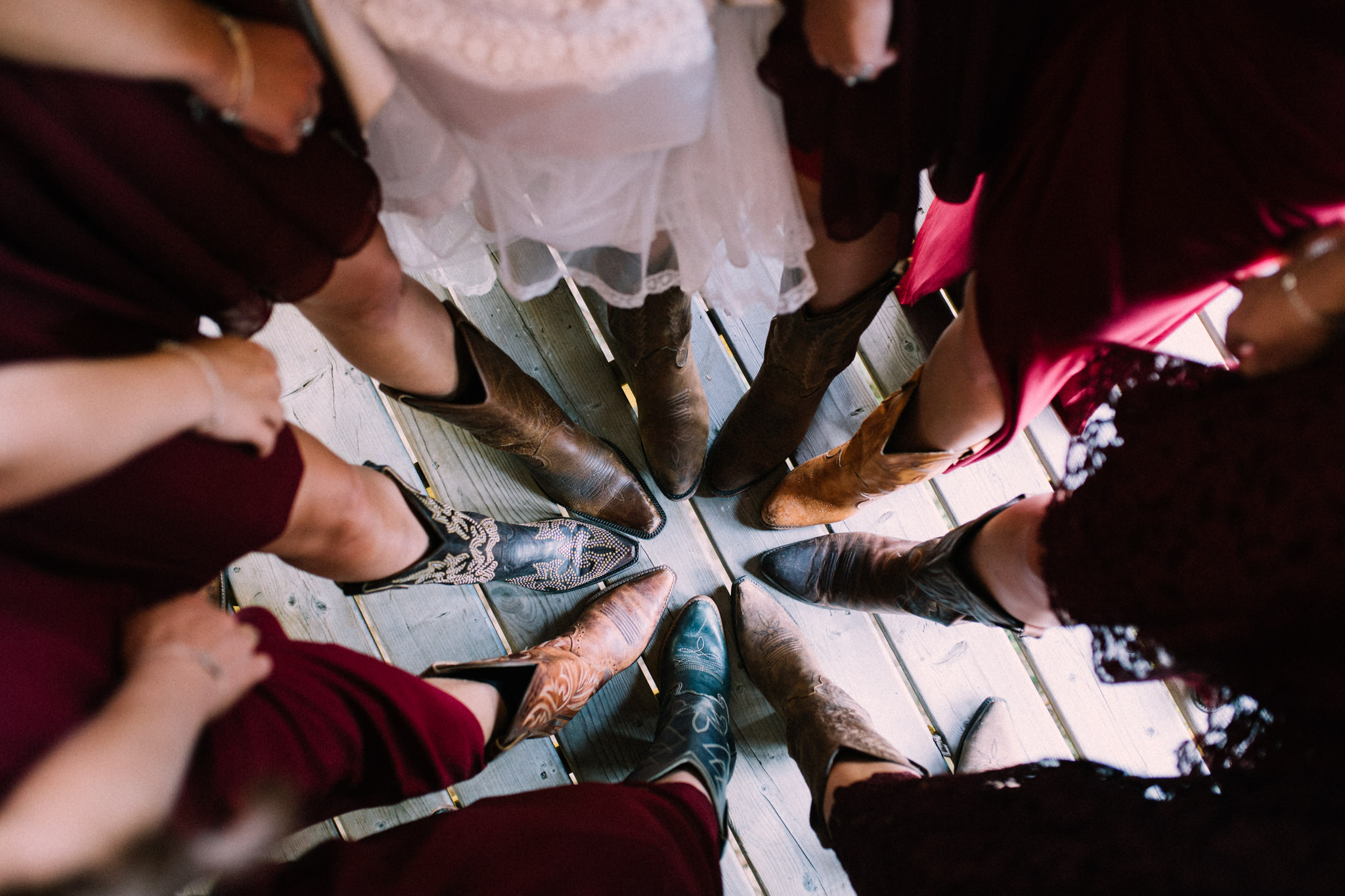 bridesmaids all wearing cowboy boots in a circle