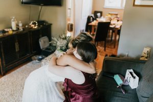 bride hugging sister