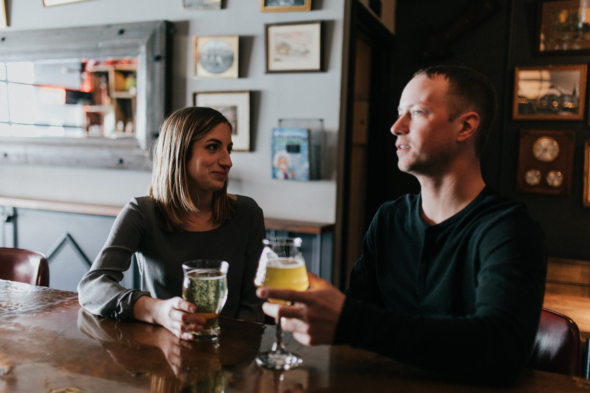 couple drinking beer at a pub in leslieville, Toronto