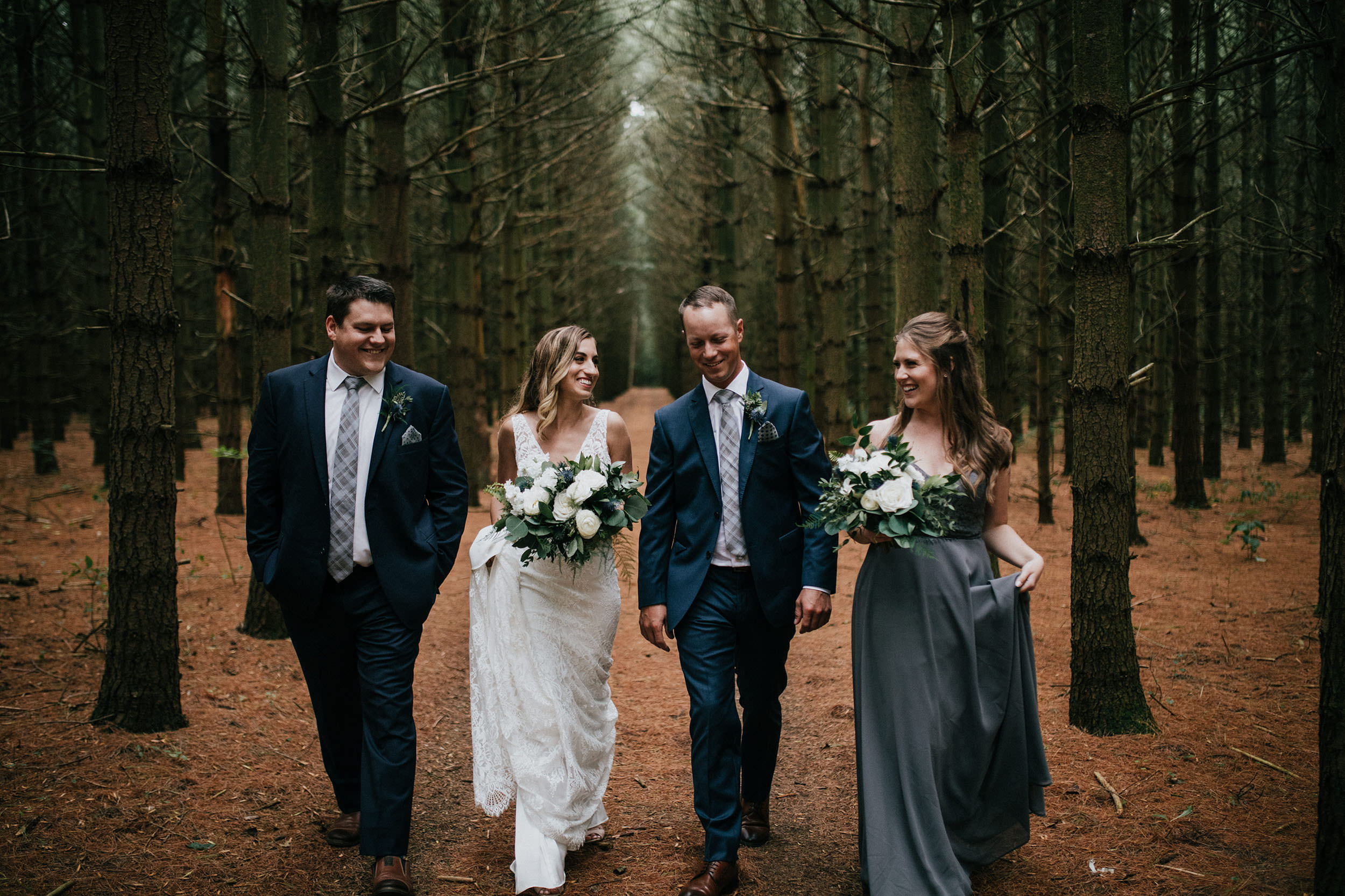 bridal party walking through wooded area