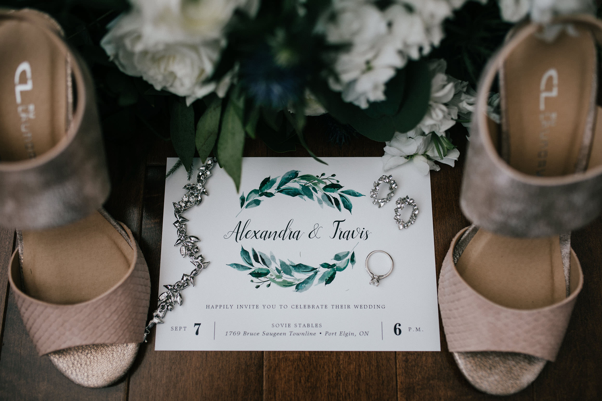 wedding invite and accessories in a flatlay
